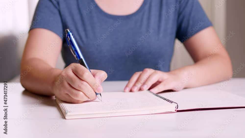 Poster close up hands taking notes on a notebook about planning for working from home in the covid-19 pande