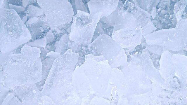 Super Slow Motion Shot of Falling and Shattering Crushed Ice on Light Background at 1000fps.