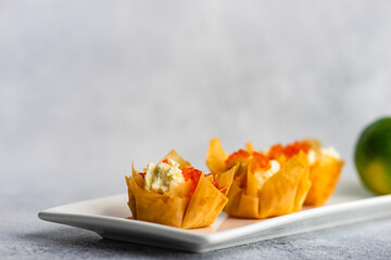 Finger food for lunch with cream cheese and red caviar