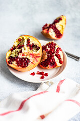 Organic ripe pomegranate on concrete background