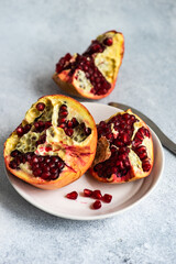Organic ripe pomegranate on concrete background