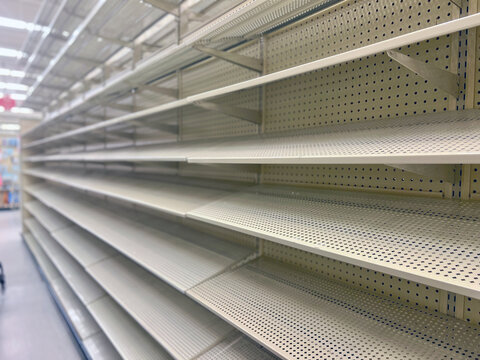 Empty shelves in a large big box department store. Stocking merchandise was problematic during the COVID-19 Coronavirus pandemic of 2021.