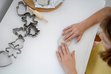 Child sculpts from polymer clay. Process of creating a New Year toy.