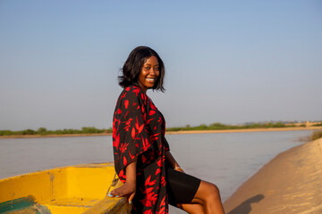 beautiful african american lady relaxing on a boat smiling