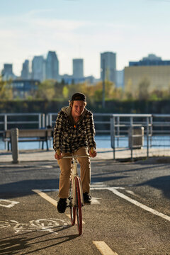Youthful man on fixed gear bike cycling around city