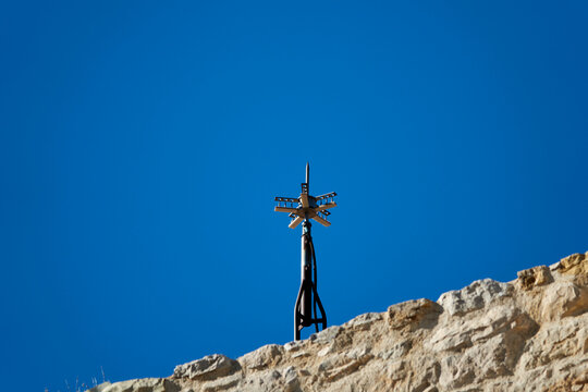 Detail of a lightning rod behind a stone wall