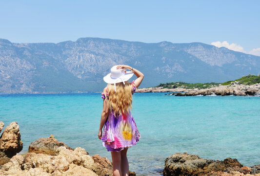 Back view of blond woman on Cleopatra Island in Turkey