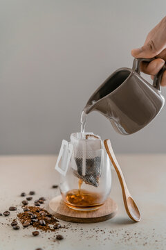 Pouring water to make filtered coffee in glass