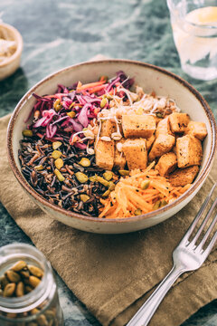 Food: budda bowl with vegetables , tofu and black rice