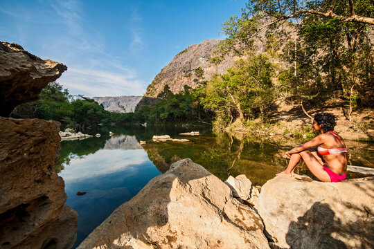 young woman relaxing at the Tha Falang river in Laos