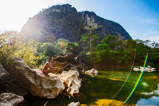 young woman relaxing at the Tha Falang river in Laos