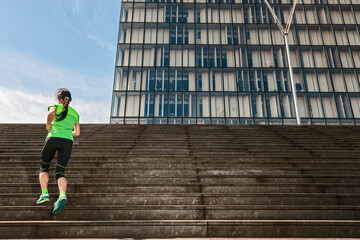 Woman running up wooden stairs in Paris