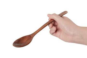 Hand holding wooden spoon on white background.