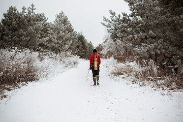 Young man with bow and arrow hunting in Wisconsin winter woods