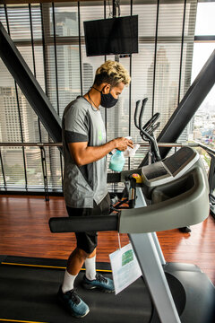 Fitness Trainer Shows Safety with Mask, Social Distancing and Cleaning