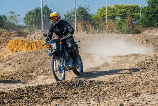 Man riding his dirt bike on off road trail close to Bangkok