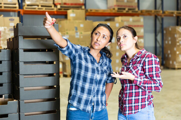 Portrait of factory warehouse manager instructs hired worker