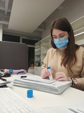 Woman at work seals envelopes