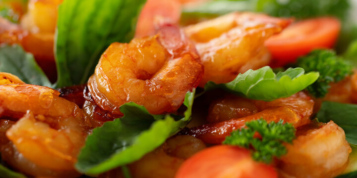 Close-up of fresh shrimp, tomato, arugula and greens salad, horizontal banner