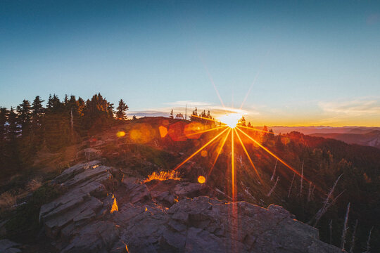 The sun is rising up above mt. Rainier National Park