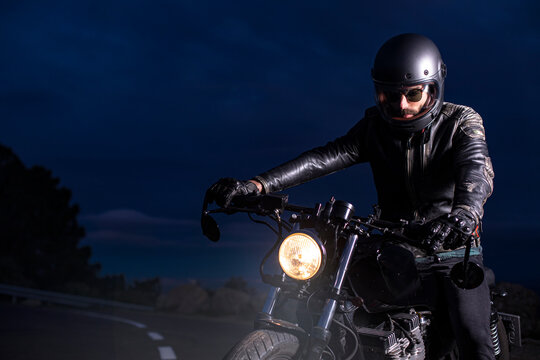 Motorcyclist on his choper motorcycle at night on the road