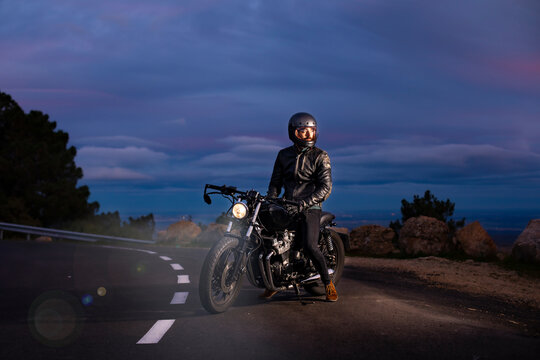Motorcyclist on his choper motorcycle at night on the road