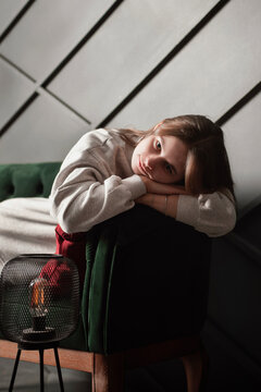 Sad girl lying on green sofa