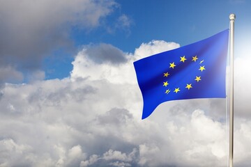 National Europe flag waving in the wind, against the blue sky with sunbeams.