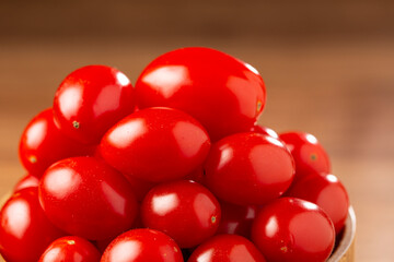 Fresh grape tomatoes in a bowl on the table.