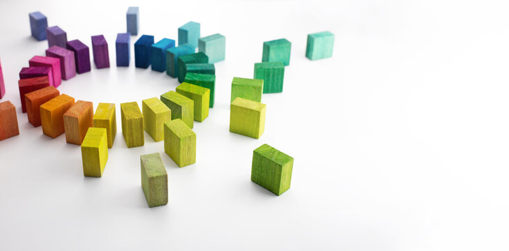 Gathering, centralization of data and people, concept image. Circle of colorful wooden blocks representing unity of diverse elements, on left side. Isolated on neutral white.