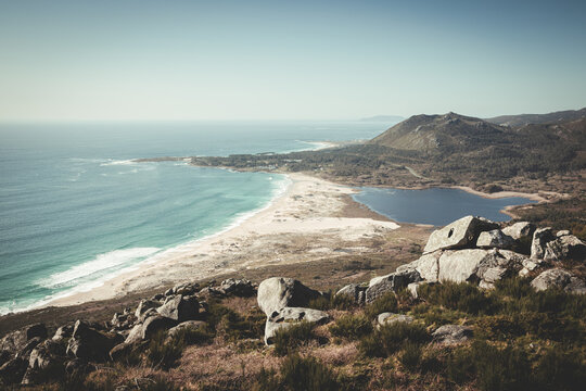 Views from above to a beach with a lake and mountains