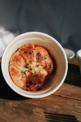 Ham Cheese Croissant with Bacon on wooden board under morning sunlight, horizontal composition. Comfort food concept