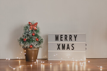 merry christmas signboard with a decorated fake pine tree
