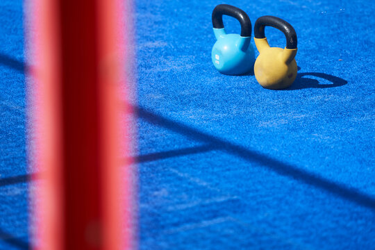 Blue and yellow kettle bell at workout outdoor gym