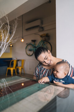 Happy Mother And His Son Having Fun At Cafe.