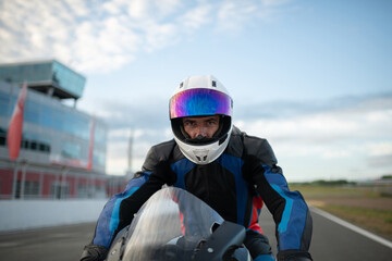 Motorcycle racer in helmet on track