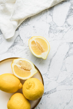 Food Flatlay of Lemons on White Marble