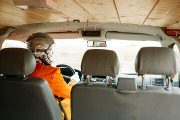 Man dressed as astronaut driving the van