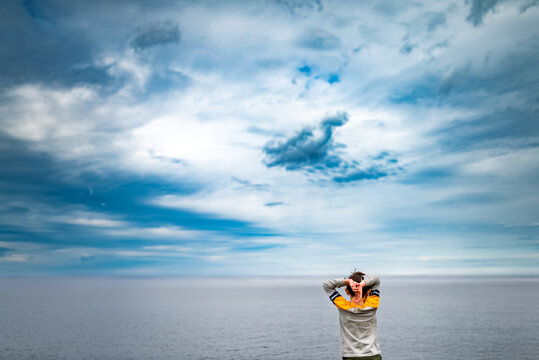 small boy overlooking the horizon on Lake Superior in Michigan