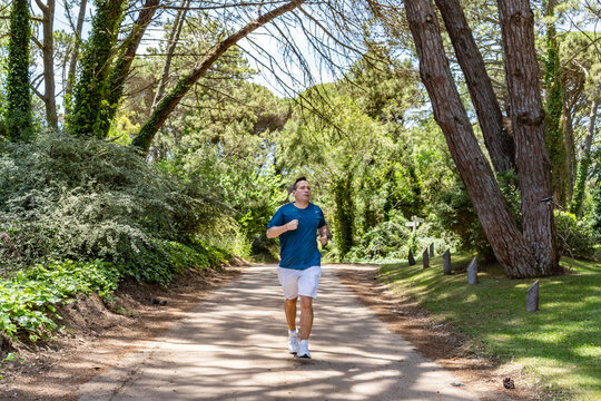 Front View of a man running outdoors training for Marathon
