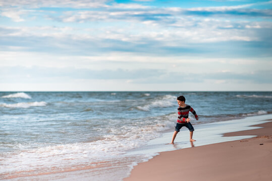 boy at Lake Michigan having fun in the water on the beach