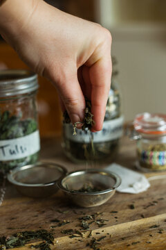 Flat lay of loose leaf herbal tea ingredients on a wooden background