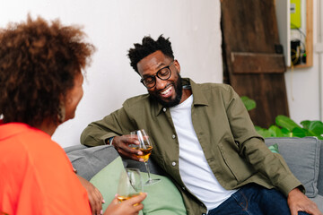 couple sitting on a couch having drinks
