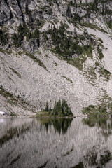 Fototapeta na wymiar Calm Waters Reflect Boulder Field in Lae