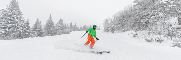 Man skiing. People on ski in Alpine ski concept - Skier skiing downhill doing hockey stop at...