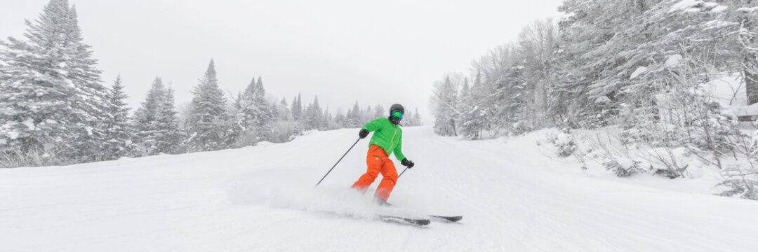 Man skiing. People on ski in Alpine ski concept - Skier skiing downhill doing hockey stop at mountain snow covered ski trail slopes in winter on perfect powder snow day in nature. Panoramic banner