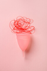 Menstrual cup isolated on pink background, menstruation cycle