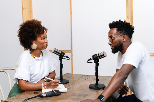 A Black Woman interviewing a guest for a podcast