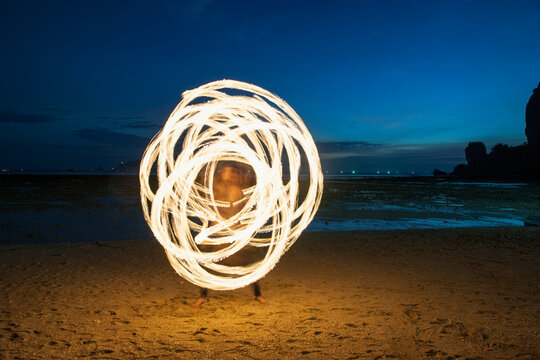 Fire dancer performing on the beach in Railay