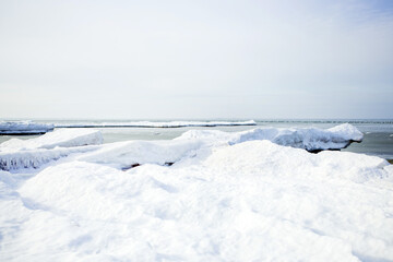 Winter seascape. Landscape of the snowy coast of the Baltic Sea. Christmas, winter. Blocks of ice.